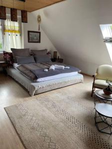 a bedroom with a large bed and a rug at Grosses 2 Zi-DG in grüner Idylle! in Bliestorf