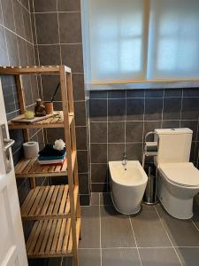 a bathroom with a toilet and a sink at Alvalade II Airport Guest House in Lisbon