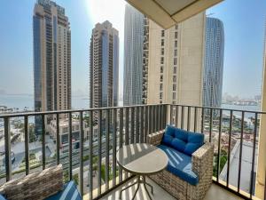 a balcony with a table and chairs and a view of the city at FAM Living - Creek Horizon - 3B with Kids Room in Dubai