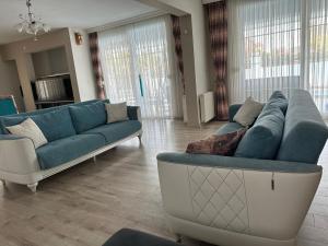 a living room with two blue couches and a couch at Villa Lina in Belek