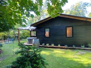 eine Blockhütte mit einer Couch im Hof in der Unterkunft Sommerhus med sjæl in Egå