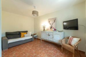a living room with a couch and a flat screen tv at Casa La venta de Pedro in Ribadesella