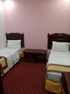 Postel nebo postele na pokoji v ubytování فندق لؤلؤة الريان الروضة