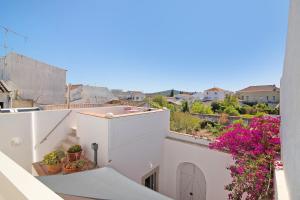 a view from the balcony of a house with flowers at Casa Rosa in São Brás de Alportel