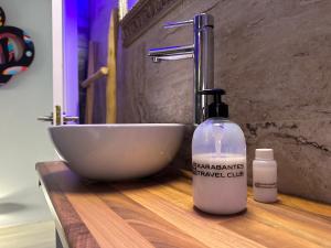 a bathroom counter with a sink and a bottle of soap at KB HOME Puertollano in Puertollano