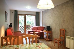 a living room with a chair and a table at Vista Arinsal Apartments in Arinsal