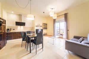 a living room with a table and chairs and a couch at Trendy Homes Envia Golf I in La Envia