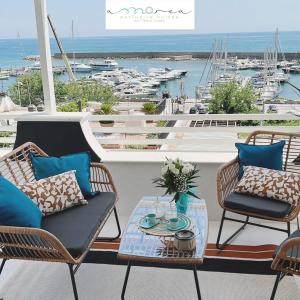 um pátio com cadeiras e uma mesa com vista para um porto em AMAREA Exclusive Suites em San Felice Circeo