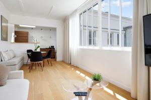 a living room with a couch and a table at Bright flat with balcony in the heart of the 7th arrondissement of Paris in Paris