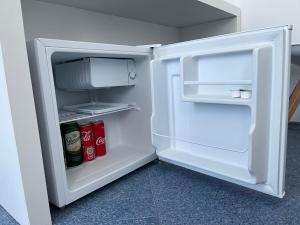 an open white refrigerator with drinks in it at Satmar in Lozenets