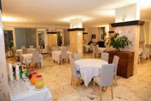 a dining room with white tables and white chairs at Hotel Park Ge.Al. in Città di Castello