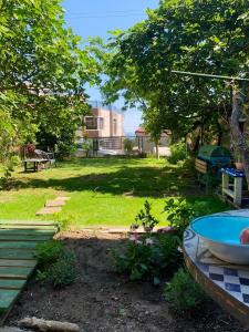 a backyard with a tub and a yard with a building at 6 bedrooms house with sea view enclosed garden and wifi at Varna in Varna City