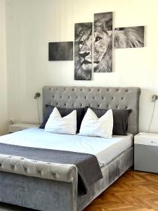 a bedroom with a bed with four pictures on the wall at Super Center in Stara Zagora