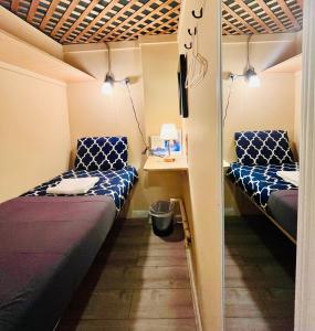 a small room with two beds and a table at New York Spirit Retreats HOSTEL in New York