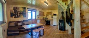a living room and kitchen in a log cabin at Domki - Noclegi Pod Ostrym Działem in Ustrzyki Dolne