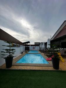 a large swimming pool sitting next to a building at Reco Villa Private Pool 4 Bedrooms@ Taman Mayung Teluk Kemang Port Dickson in Port Dickson