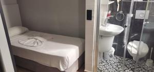 a small bathroom with a small bed and a sink at Aslan Sand & City Hotel in Alanya