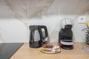 a coffeemaker and a coffee maker on a counter at Athens Connection Apartments in Athens