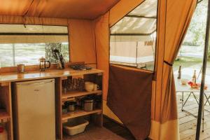 an interior view of a kitchen in a tent at Camping Onlycamp Domelin in Beaufort