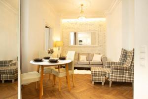 a living room with a table and chairs and a couch at City Center - Cozy And Bright - Dobra11 in Warsaw