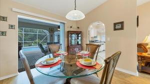 a dining room with a glass table and chairs at 26360 Copiapo in Port Charlotte