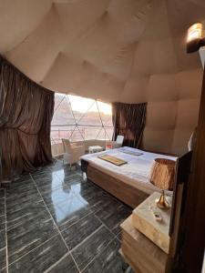 a large room with a bed and a window at Orbit camp in Wadi Rum