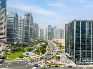 a highway in a city with many tall buildings at Cosmos Living Spacious Studio With Balcony in Dubai