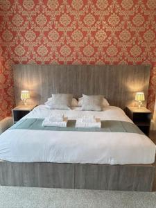 1 dormitorio con 1 cama grande y 2 toallas. en Arrandale Guest House, en Edimburgo