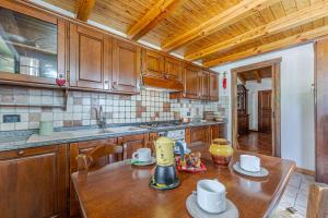 a kitchen with wooden cabinets and a wooden table at Casa Beatrice in Courmayeur