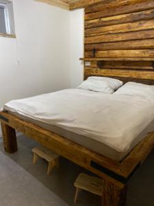 a large bed with a wooden headboard in a room at Pura Vida in Zaječí