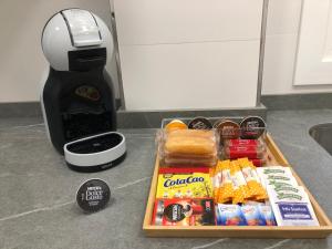 a tray of food on a counter next to a coffee maker at Apartamento Vicaño - PLAYA SILGAR in Sanxenxo