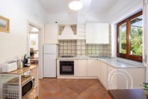 een keuken met witte kasten en een fornuis met oven bij Country Life Relais in Massa Lubrense