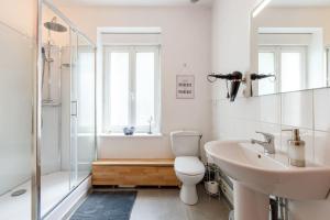 a bathroom with a toilet and a sink and a shower at Gîte du Château in Naours +12 photos