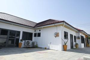 a white house with a lot of windows at Lokko Serene in Accra