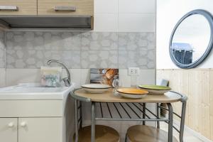 A kitchen or kitchenette at San Nicola Apartments by Rentbeat