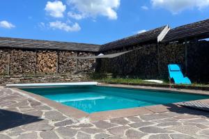 a swimming pool in front of a house with a rock wall at Sleep Space 1 - Green Tiny Spot Dolmar 