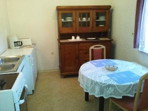 a small kitchen with a table and a sink at Sleep in Lerbach in Osterode