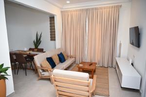 a living room with a couch and a table at Lokko Serene in Accra