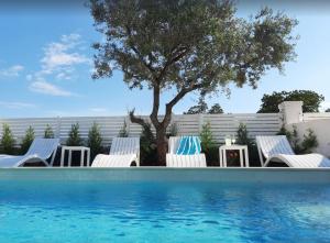 a group of chairs sitting next to a swimming pool at Apartment Adriana in Supetar