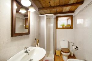 a bathroom with a sink and a toilet and a mirror at Casa Rural Ciso in Tijarafe +17 photos