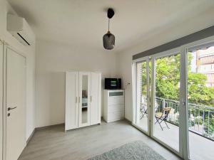 a living room with a door and a balcony at CYTRUS apartament in Marina di Massa