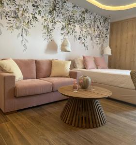 a living room with a couch and a table at Loutraki Flamingo Feather in Loutraki