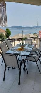 a table and chairs on a patio with a view of the ocean at Sea flight in Preveza