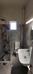 a bathroom with a white toilet and a sink at Sea flight in Preveza +10 photos