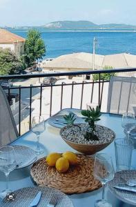 a table with a bowl of fruit on top of it at Sea flight in Preveza