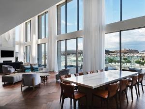 a living room with a table and chairs at Grand Hyatt Athens in Athens