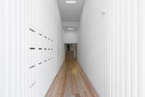 un pasillo con paredes blancas y suelo de madera en Elegant 2BR Duplex in City Center by LovelyStay en Oporto