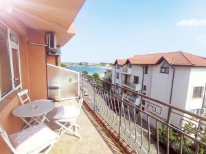 a balcony with a table and chairs on a building at Dream House in Tsarevo