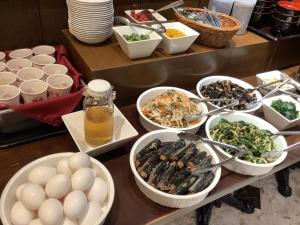 a buffet with eggs and bowls of food on a table at APA Hotel & Resort Nishishinjuku-Gochome-Eki Tower in Tokyo