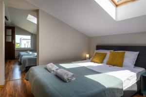 弗瓦迪斯瓦沃沃的住宿－Złoty Piach，一间卧室配有两张带黄色和绿色枕头的床